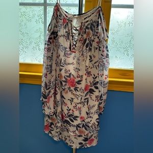 Woman’s large floral open shoulder dress